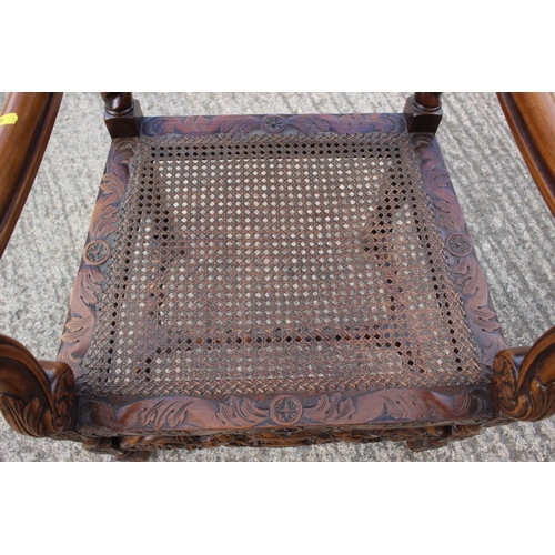 371 - A Restoration design carved walnut carver chair with oval cane back and seat, on barley twist stretc... 