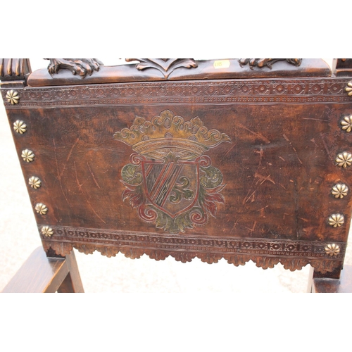 374 - A Renaissance Revival carved walnut armchair with lion and coat of arms top rail, and leather seat a... 