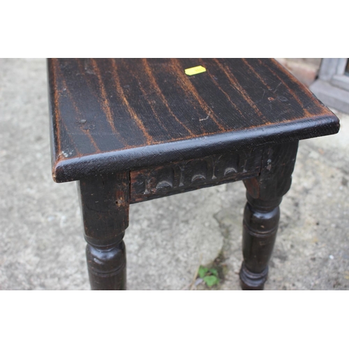 378 - An oak rectangular stool with carved frieze, on turned supports, 18