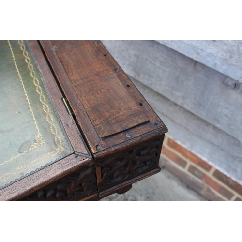 386 - A 19th century carved oak and blind fretwork desk, fitted tooled lined top, on panel end supports, 2... 