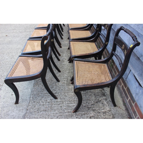 393 - A set of twelve Regency ebonised and brass rope mounted rope twist bar back dining chairs with cane ... 