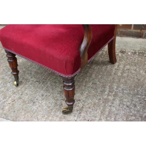 404 - A 19th century rosewood showframe open armchair, upholstered in a cinnabar velour, on turned and cas... 