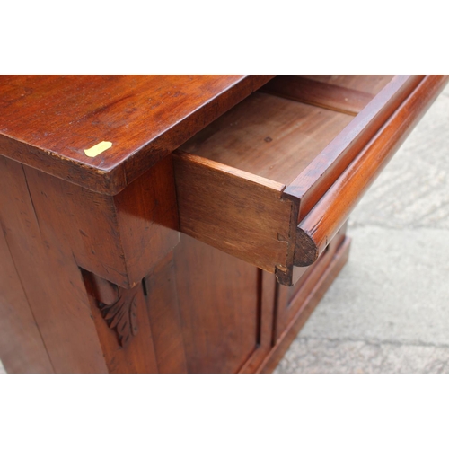 406 - A late 19th century mahogany ledge back chiffonier with frieze drawer over cupboards, on block base,... 