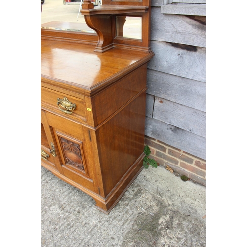 429 - A late 19th century carved oak dresser with raised back mirrors and shelves, over three drawers, cen... 