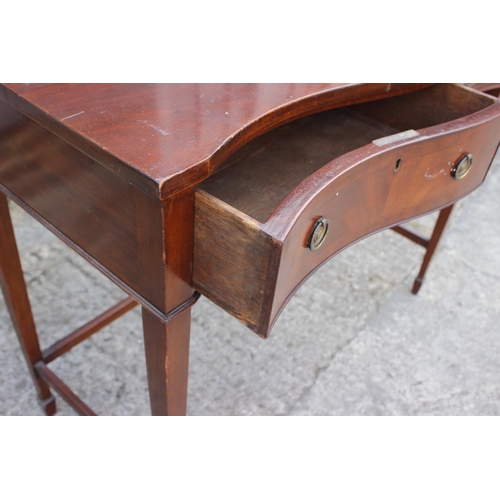 506 - A mahogany serpentine top table, fitted two drawers, on square taper supports, 41 1/2