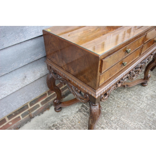 541 - A 1930s burr walnut table canteen, fitted four short drawers, on cabriole supports united by an unde... 