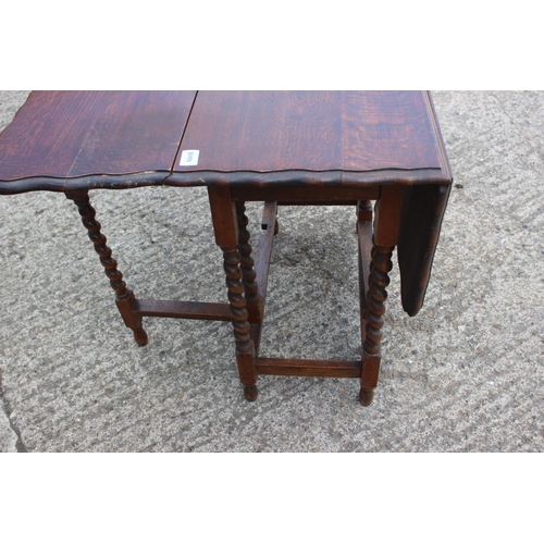 561 - An oak drop leaf dining table, on barley twist supports, 41