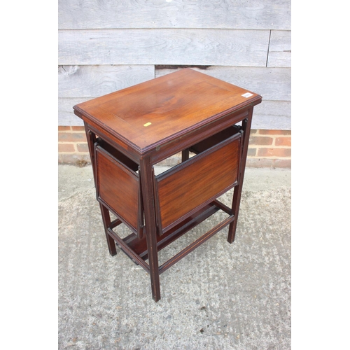 562 - An Edwardian mahogany fold-over top card and tea table with four drop down slides, on moulded suppor... 