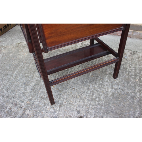 562 - An Edwardian mahogany fold-over top card and tea table with four drop down slides, on moulded suppor... 