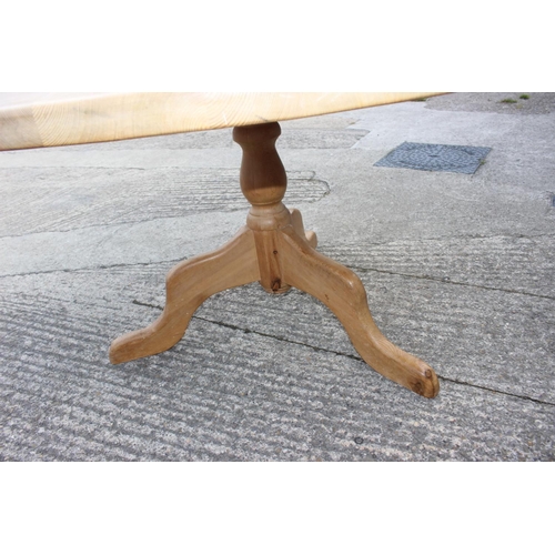 589 - A scrubbed pine circular pedestal table, on tripod splay supports, 54