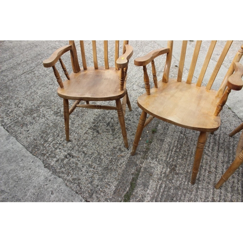 592 - A set of four lath back elbow chairs, on turned and stretchered supports