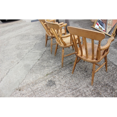 592 - A set of four lath back elbow chairs, on turned and stretchered supports