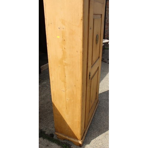 602 - A late 19th century waxed pine cupboard enclosed panel door with brass grill, on bracket feet, 36