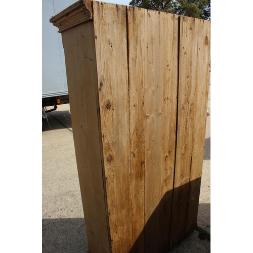 602 - A late 19th century waxed pine cupboard enclosed panel door with brass grill, on bracket feet, 36