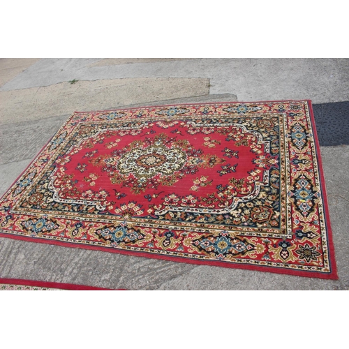 608 - A rug of traditional Continental design on a red ground, 114