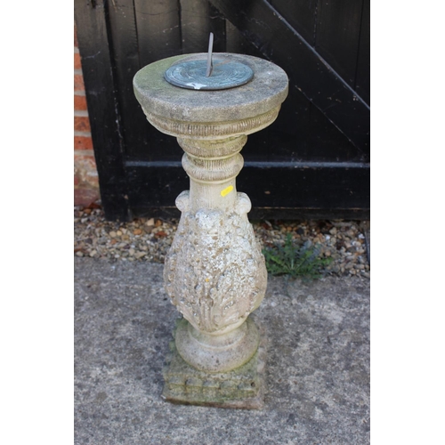 623 - A cast stone sundial pillar with acanthus leaf decoration and a brass sundial