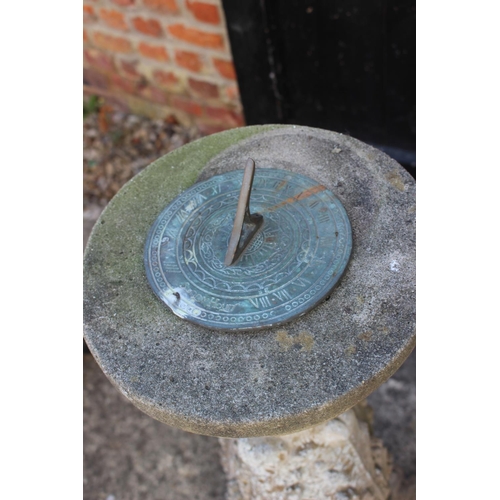 623 - A cast stone sundial pillar with acanthus leaf decoration and a brass sundial