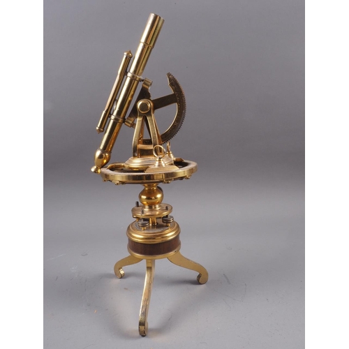 110 - A reproduction Burke & Jones brass theodolite, on tripod supports, 12 1/4