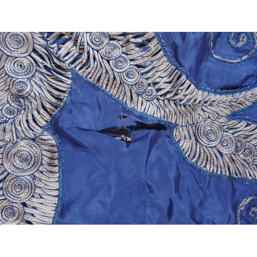 169 - An early 20th century blue silk shawl with ribbon and tassel decoration, 44