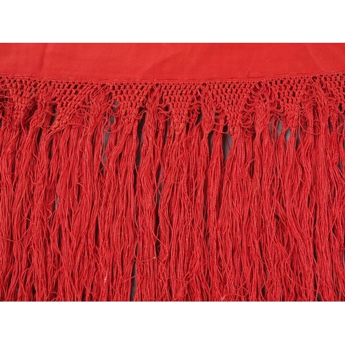 170 - An early 20th century red silk shawl with embroidery and tassel decoration, 64