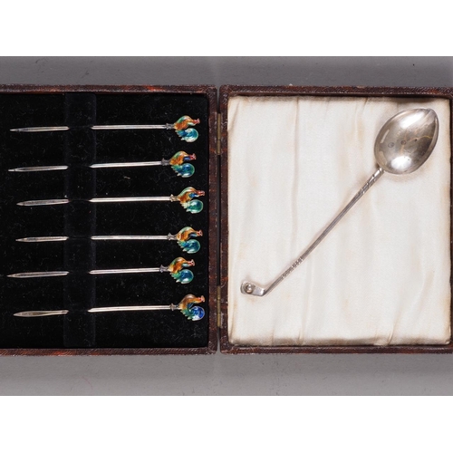 233 - A set of six silver gilt and enamelled coffee spoons, six silver cocktail sticks, mounted cockerels,... 