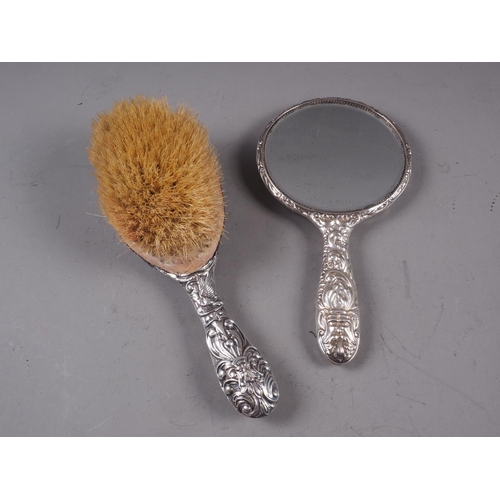 235 - A silver backed mirror and brush, a silver plated sovereign case, a plated mounted notebook and two ... 