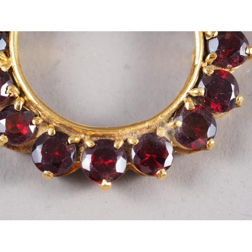 247 - A 9ct gold and garnet circular pendant, 1 1/4