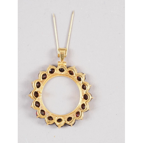 247 - A 9ct gold and garnet circular pendant, 1 1/4