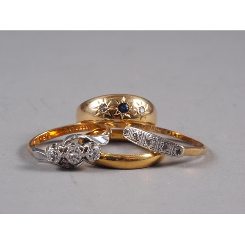 252 - A 22ct gold wedding band, size N, 3.9g, an 18ct gold three-stone gypsy ring, a yellow and white meta... 