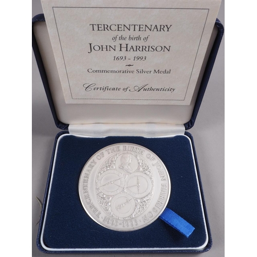 264 - A Royal Mint silver medallion, commemorating the Tercentenary of the birth of John Harrison, and two... 