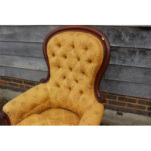 419 - A Victorian mahogany showframe button back armchair, upholstered in a gold floral fabric, and a matc... 