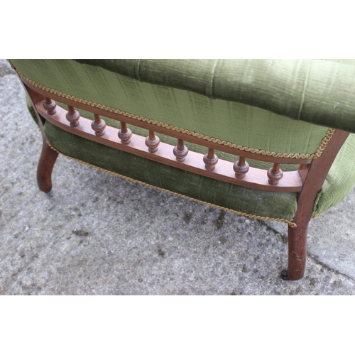 434 - A late 19th century carved walnut showframe two-seat settee, button upholstered in a green velour, o... 