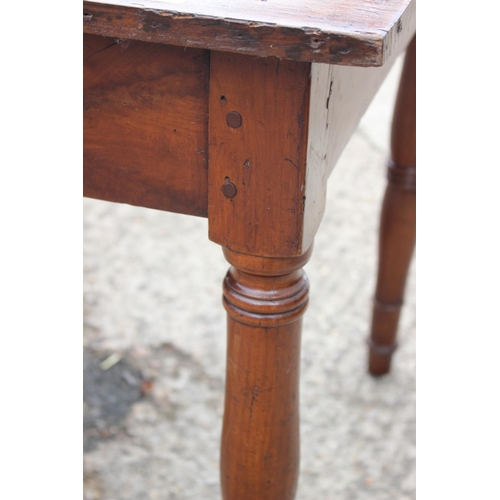 438 - An antique French cherrywood farmhouse table, fitted one drawer, on turned supports, 66