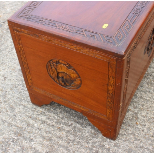 480 - A Chinese carved camphor wood chest, on bracket feet, 37