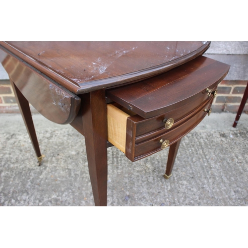 497 - A mahogany oval drop leaf table, fitted one deep drawer, on tapering supports, 36