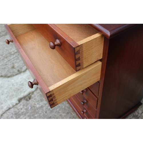 521 - A mahogany chest of seven drawers with knob handles, on block base, 20