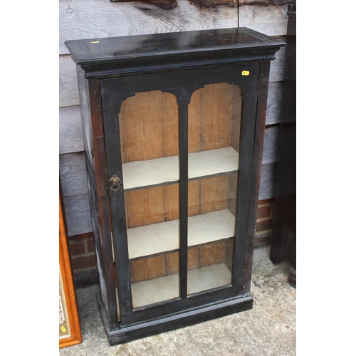 531 - An ebonised bookcase enclosed single leaded glazed door, 21