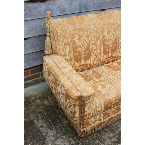 548 - A Knole two-seat settee, upholstered in an heraldic fabric, 55