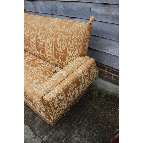 548 - A Knole two-seat settee, upholstered in an heraldic fabric, 55