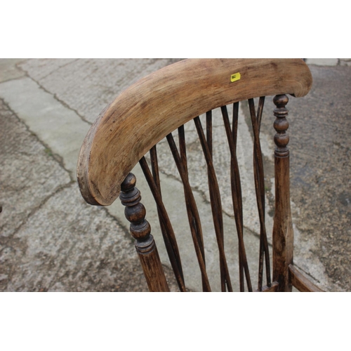 550 - An early 20th century Windsor 5 X lath back elbow chair, on turned supports