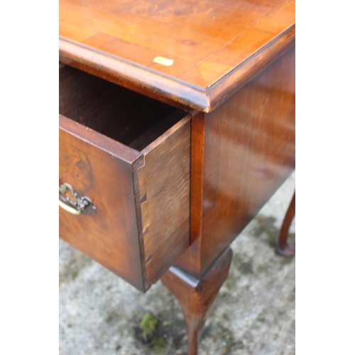 575 - A walnut low boy of early Georgian design, fitted one shallow and two deep drawers, on cabriole supp... 