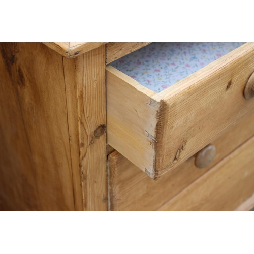 599 - A stripped pine ledge back chest of two short and two long drawers with knob handles, on turned supp... 