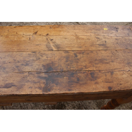 601 - A 19th century waxed pine dresser base, fitted three drawers, on turned supports, 60