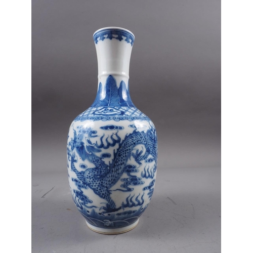 72 - A Chinese blue and white baluster two-handled vase, decorated mythical beasts and clouds with four-c... 