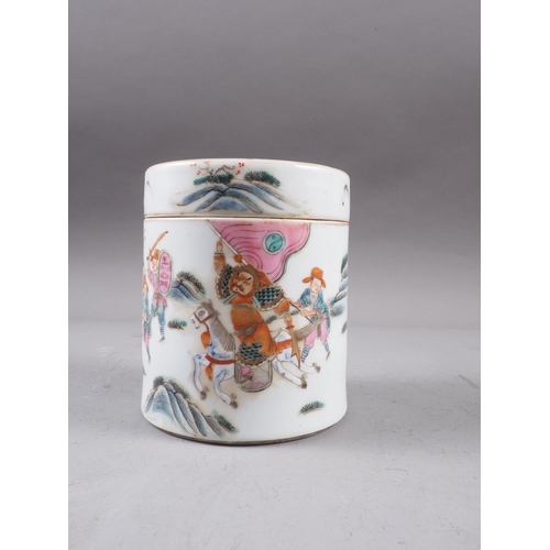 74 - A Chinese famille rose cylindrical box and cover, decorated figures in a landscape with seal mark to... 