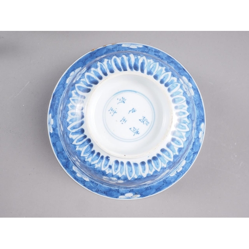 86 - A Chinese blue and white bowl with floral decoration and six-character mark to base, 8