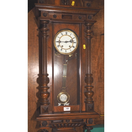 109 - An American cased wall clock with glazed panels and eight-day striking movement, 42