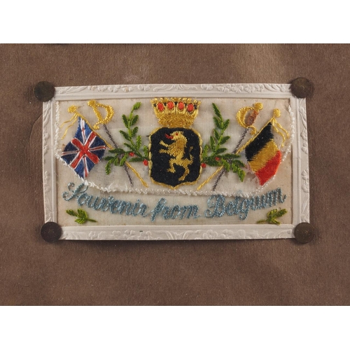 215 - A collection of eighteen WWI silk embroidered post cards, in two maple frames, and two colour prints... 