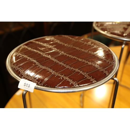 513 - A pair of chrome circular stools, upholstered in a mock crocodile fabric, 17 1/2