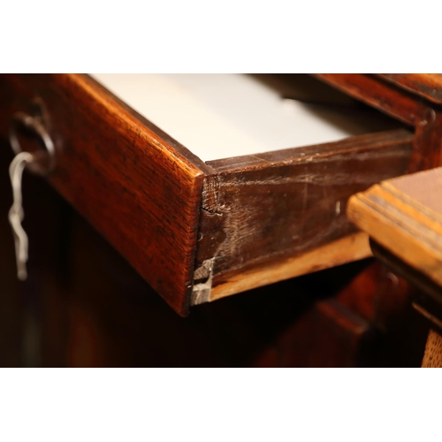 516 - A Continental oak sideboard, fitted three drawers over two cupboards with fielded panels, on cabriol... 